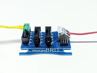 Side profile of a QS-12 series breakout board connected to an electronic firing system.