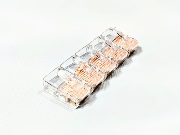 Several RJ45 shunts lined up next to each other