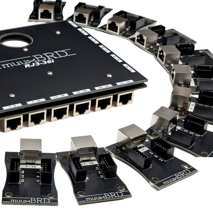 Close up view of the RJ3-36i RJ45 breakout board along side eighteen 6-cue slats
